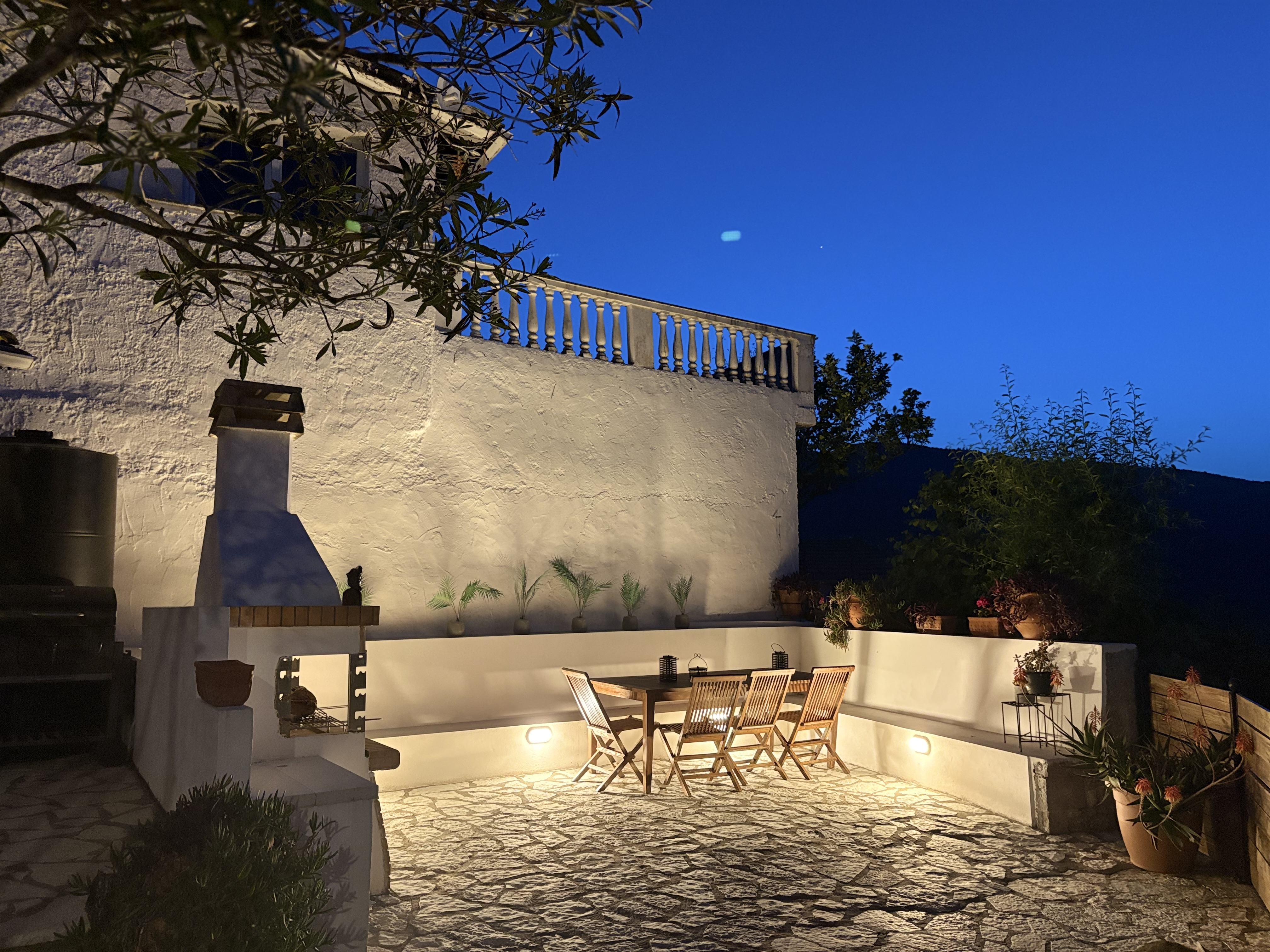 Paved garden and outdoor seating area at night